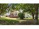 Backyard featuring a wooden deck, mature trees, and a well-maintained lawn offering a serene outdoor space at 113 Kelly Ln, Clayton, NC 27520