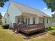 View of a backyard featuring a wooden deck with steps, and a covered porch area with seating at 113 Kelly Ln, Clayton, NC 27520