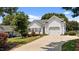 View of a house featuring a wide driveway, a two-car garage, and lush greenery at 113 Kelly Ln, Clayton, NC 27520