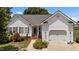 Charming single-Gathering home features a well-maintained lawn, a two-car garage, and a welcoming entrance at 113 Kelly Ln, Clayton, NC 27520