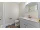 Bright bathroom with a white vanity, toilet, and shower visible in the mirror at 1209 Waterford Green Dr Dr, Apex, NC 27502