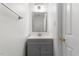 Bright bathroom features a gray vanity with a white countertop and a large, well-lit mirror at 1209 Waterford Green Dr Dr, Apex, NC 27502