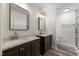 Modern bathroom with double vanities, framed mirrors, and a walk-in shower at 1209 Waterford Green Dr Dr, Apex, NC 27502