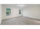 Bright bedroom with neutral carpet, two windows, and fresh white paint at 1209 Waterford Green Dr Dr, Apex, NC 27502