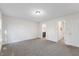Spacious bedroom with neutral carpet, white walls, with doorways to the bathroom and hallway at 1209 Waterford Green Dr Dr, Apex, NC 27502