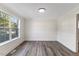 Bright dining room featuring large windows, chair rail, and modern gray flooring at 1209 Waterford Green Dr Dr, Apex, NC 27502