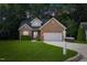 Charming brick home with a well-manicured lawn and two-car garage, perfect curb appeal at 1209 Waterford Green Dr Dr, Apex, NC 27502
