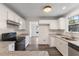 Modern kitchen with white cabinets, granite countertops, and stainless steel appliances at 1209 Waterford Green Dr Dr, Apex, NC 27502