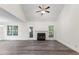 Bright and airy living room with a fireplace, vaulted ceiling, and sleek flooring at 1209 Waterford Green Dr Dr, Apex, NC 27502