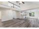Open-concept living room featuring a vaulted ceiling, fireplace, and modern flooring, plus a view of the kitchen at 1209 Waterford Green Dr Dr, Apex, NC 27502