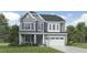 Charming two-story home featuring a stone-accented facade, a gray color palette, and an attached two-car garage at 1221 Coral Cay Bnd, Wake Forest, NC 27587