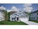 Charming one-story home features a light blue exterior, manicured lawn, and attached two-car garage at 124 Sugarmaple Way, Youngsville, NC 27596