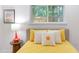 Bright bedroom features a window and stylish decor at 1309 Hudson Ave # D5, Durham, NC 27705