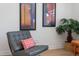 Comfortable chair, indoor plant, and artwork enhance the inviting living room space at 1309 Hudson Ave # D5, Durham, NC 27705