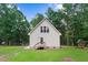 View of the home's backyard with swingset and wooded area at 132 Ironwood Ln, Clayton, NC 27520