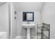 Bathroom with single sink, pedestal sink, and metal shelving unit at 132 Ironwood Ln, Clayton, NC 27520