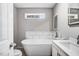Modern bathroom with a freestanding tub, stylish vanity, and sleek fixtures for a spa-like experience at 132 Ironwood Ln, Clayton, NC 27520