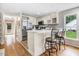Bright kitchen featuring stainless steel appliances, white cabinetry and a breakfast bar with seating at 132 Ironwood Ln, Clayton, NC 27520