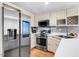 Stylish kitchen featuring stainless steel appliances, white cabinets, and a smart refrigerator at 132 Ironwood Ln, Clayton, NC 27520