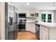 Modern kitchen features stainless steel appliances, white cabinets, and a functional countertop at 132 Ironwood Ln, Clayton, NC 27520