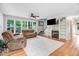 Cozy living room features a fireplace, built-in shelving, and plush seating for relaxing at 132 Ironwood Ln, Clayton, NC 27520