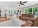 Spacious open-concept living area with a kitchen view, hardwood floors, and comfortable sofas at 132 Ironwood Ln, Clayton, NC 27520
