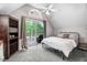 Inviting bedroom with a ceiling fan, sliding glass doors to a deck, and ample natural light at 132 Ironwood Ln, Clayton, NC 27520
