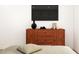 Bedroom features a wooden dresser with a sleek design and a black television above at 17 Runneymede Pl, Smithfield, NC 27577