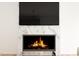 Modern fireplace with a large television above it, great for entertaining at 17 Runneymede Pl, Smithfield, NC 27577
