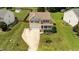 Aerial view showcasing a charming home with a well-kept lawn, inviting porch, and convenient two-car garage at 1713 Mclaurin Ln, Fuquay Varina, NC 27526