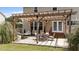 A close up of the outdoor patio area with furniture, a pergola and hammock in the fenced backyard of a home at 1713 Mclaurin Ln, Fuquay Varina, NC 27526