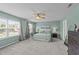 Spacious bedroom featuring a ceiling fan, a comfortable king-sized bed, and natural light from the windows at 1713 Mclaurin Ln, Fuquay Varina, NC 27526