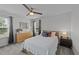 Bedroom with a white comforter on a bed, dark wood night stand, and gray carpeting at 1713 Mclaurin Ln, Fuquay Varina, NC 27526