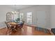 Inviting dining room with hardwood floors, a wooden table, and ample natural light, perfect for Gathering gatherings at 1713 Mclaurin Ln, Fuquay Varina, NC 27526