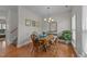 Charming dining room with hardwood floors, wood table and chairs, and bright natural light at 1713 Mclaurin Ln, Fuquay Varina, NC 27526
