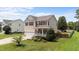 Charming home featuring a well-manicured lawn, complemented by vibrant plants and a welcoming front porch at 1713 Mclaurin Ln, Fuquay Varina, NC 27526