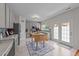 Updated kitchen with modern appliances, gray cabinets, and adjacent dining area with bright lighting at 1713 Mclaurin Ln, Fuquay Varina, NC 27526