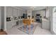 Modern kitchen features gray cabinets, stainless steel appliances, and a wooden dining table at 1713 Mclaurin Ln, Fuquay Varina, NC 27526