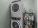 Laundry area with stacked washer and dryer and black wire shelving at 1713 Mclaurin Ln, Fuquay Varina, NC 27526