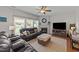 Inviting living room with a fireplace, hardwood floors, and large windows for natural light at 1713 Mclaurin Ln, Fuquay Varina, NC 27526