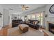 Bright living room featuring hardwood floors, comfortable seating, and a cozy fireplace at 1713 Mclaurin Ln, Fuquay Varina, NC 27526