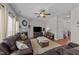Spacious living room with hardwood floors, a fireplace, and comfortable seating arrangement at 1713 Mclaurin Ln, Fuquay Varina, NC 27526