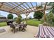 Outdoor patio area with dining set, grill, hammock, and pergola at 1713 Mclaurin Ln, Fuquay Varina, NC 27526