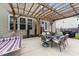Back patio featuring a pergola, outdoor dining set, hammock, and grill at 1713 Mclaurin Ln, Fuquay Varina, NC 27526
