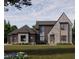 Modern two-story home featuring a stone and wood facade, large windows, and a well-manicured lawn at 1725 Legacy Ridge Ln, Wake Forest, NC 27587