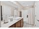 Well-lit bathroom with dark wood cabinets, quartz countertop, modern fixtures, and tile floor at 1806 Pattersons Mill Rd, Durham, NC 27703