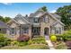 Charming two-story home featuring a stone and siding exterior and beautifully landscaped front yard at 1806 Pattersons Mill Rd, Durham, NC 27703