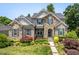 Charming two-story home with a stone and brick facade, manicured landscaping, and a welcoming front entrance at 1806 Pattersons Mill Rd, Durham, NC 27703