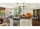 Kitchen island with seating and stainless steel appliances offers open living concept at 1806 Pattersons Mill Rd, Durham, NC 27703
