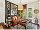Charming living area featuring unique decor, comfortable seating, and ample natural light from the door to the outside at 1806 Pattersons Mill Rd, Durham, NC 27703